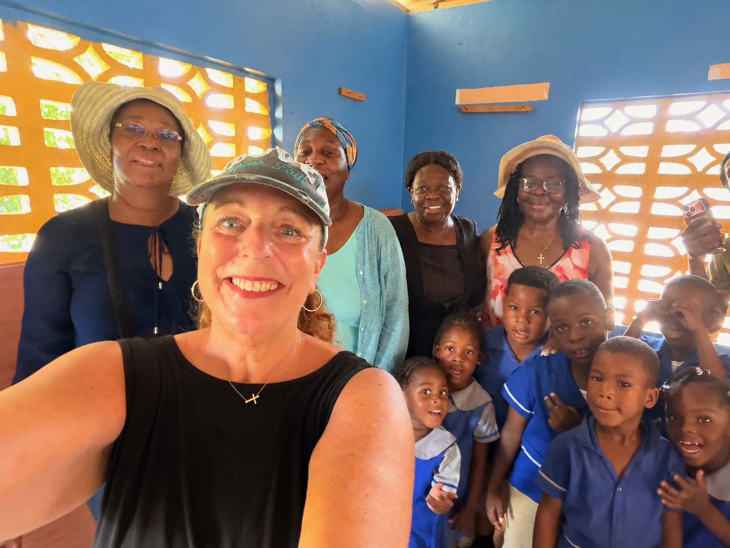 Project Grateful Hearts founder Kat Weir with women and children during community outreach in Jamaica